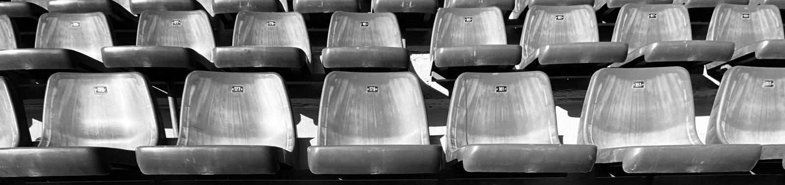 Rows of empty stadium seats used as the Continue exploring background.