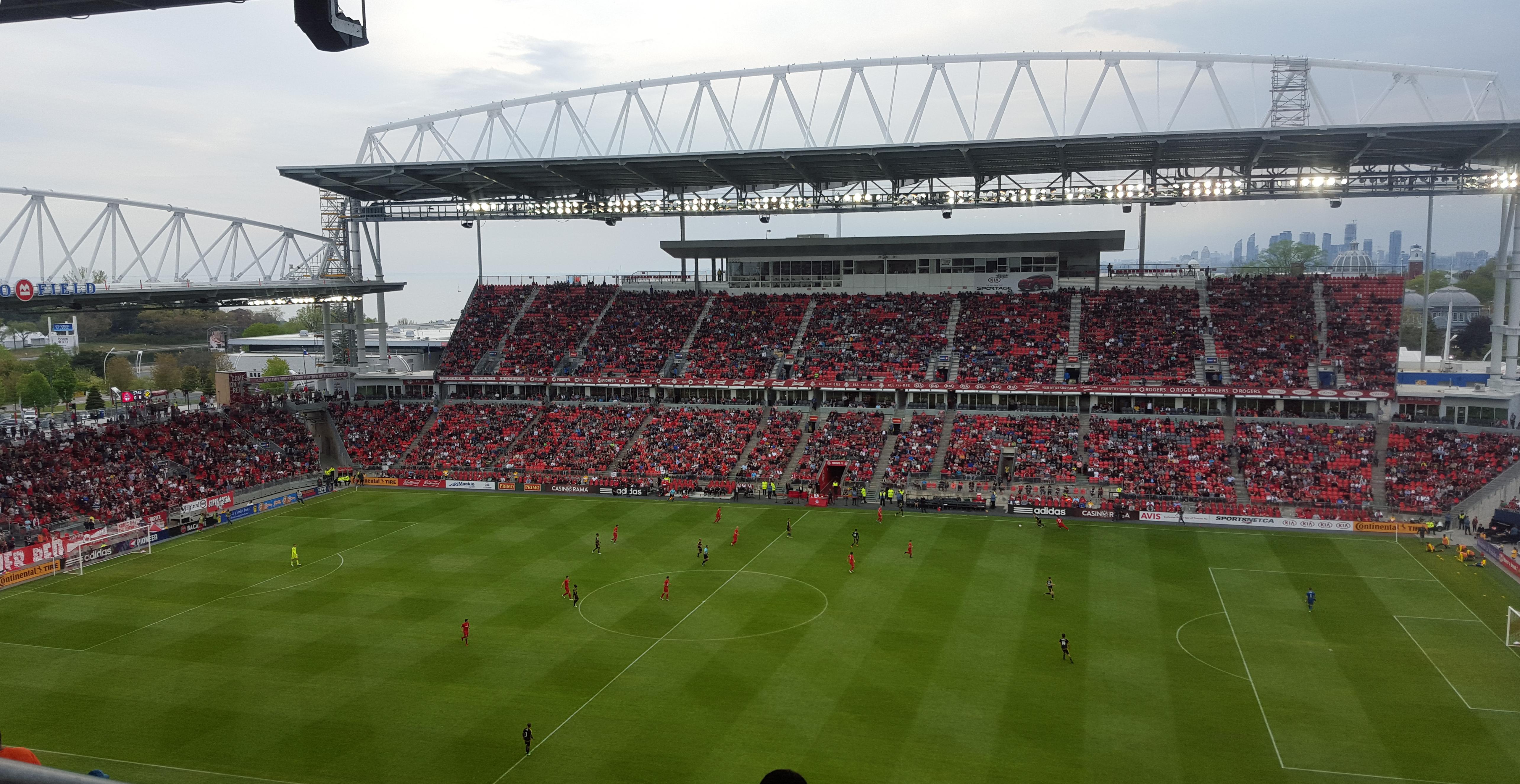 BMO Field Toronto during a match with full stands, renovated upper tier and the city skyline visible in the background
