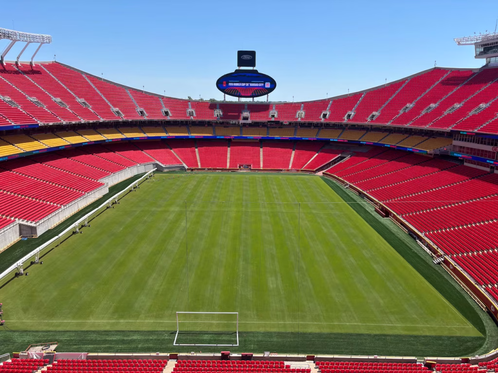 Interior view of Arrowhead Stadium with a football pitch installed, showing removed lower rows on the left side to create enough space for the wider field.